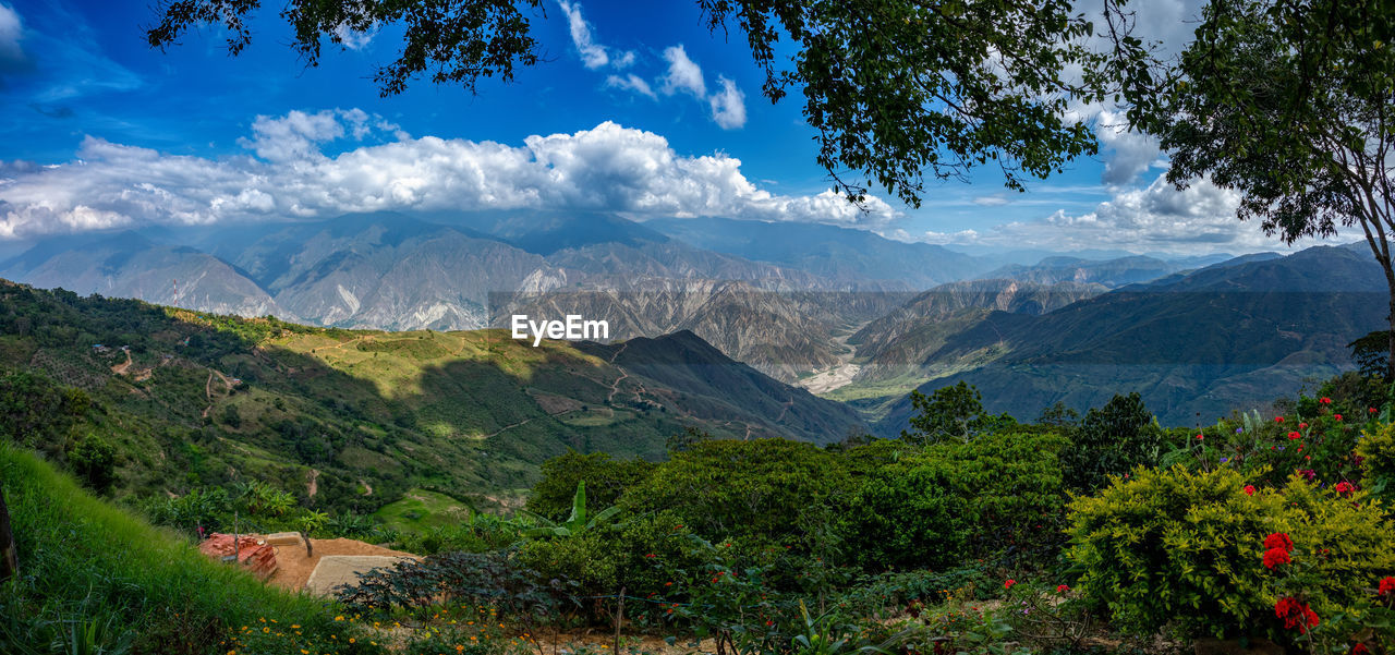 scenic view of mountains against cloudy sky
