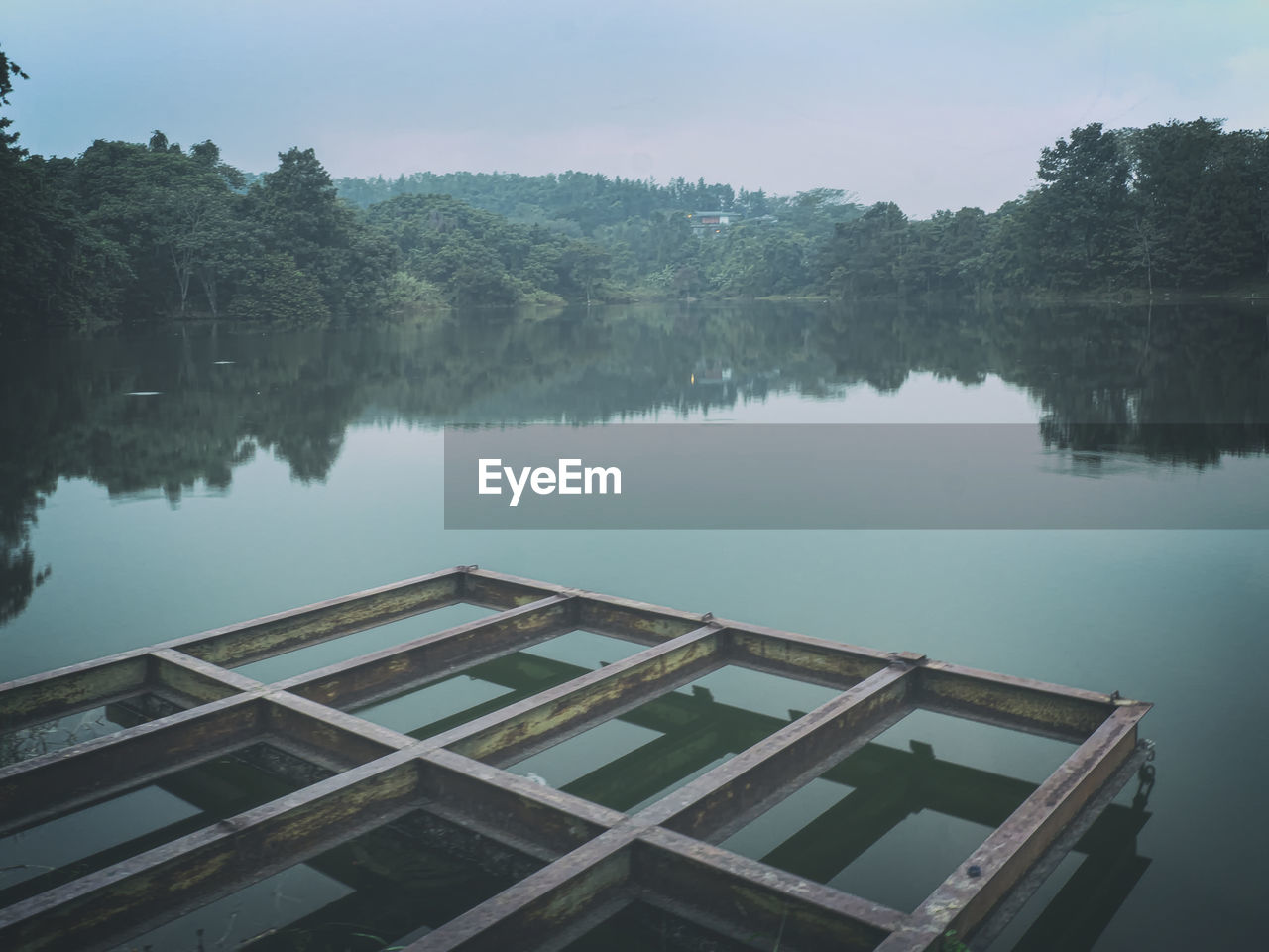 High angle view of swimming pool by lake against sky