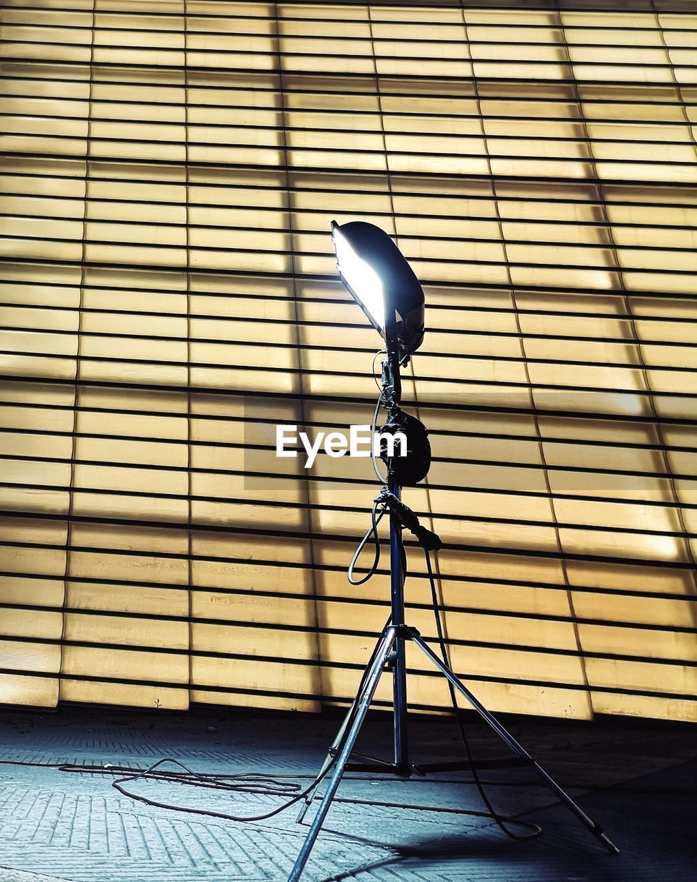 Close-up of electric lamp against crystal building. 