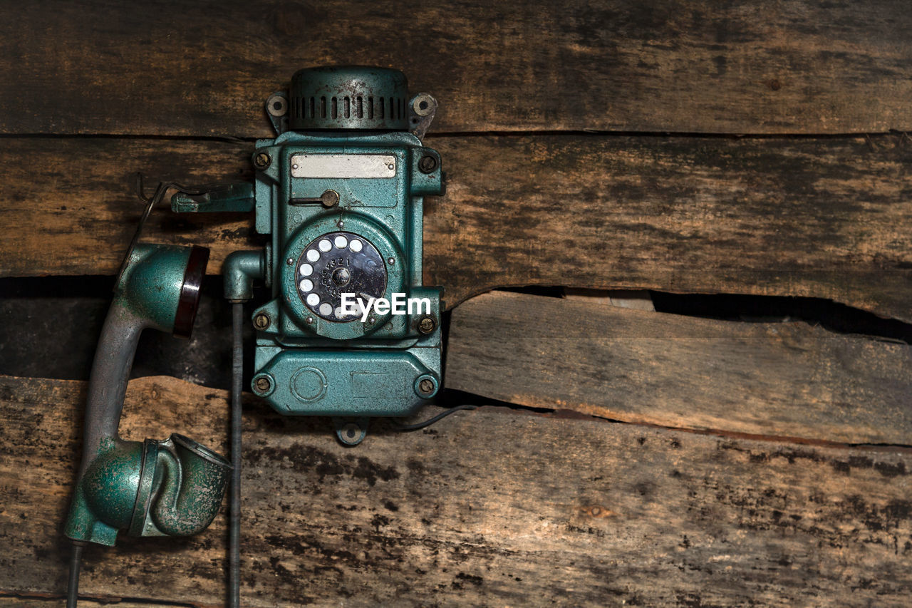 Old vintage sity telephone on an old wooden wall for use in a mine