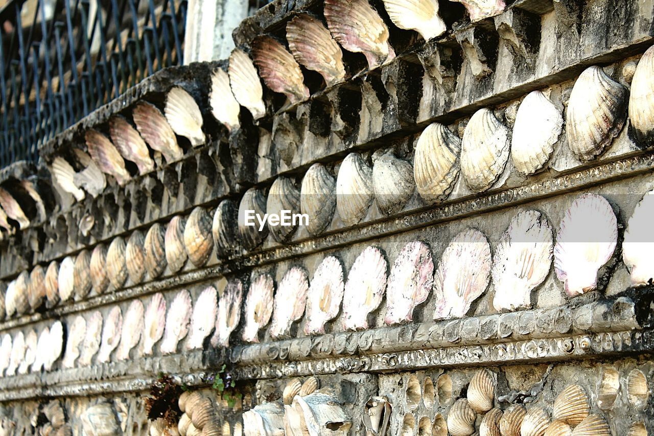 Part of building exterior decorated with seashells