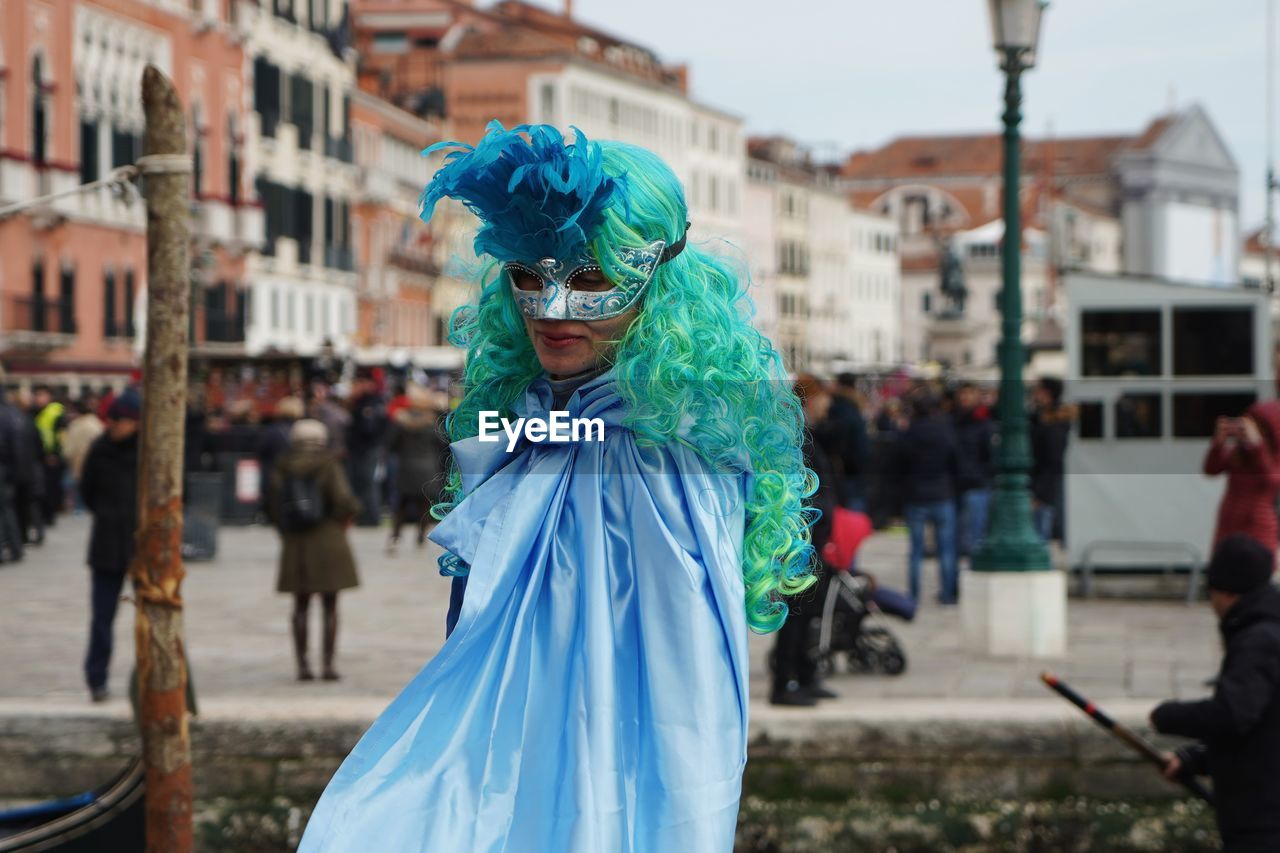 Woman wearing mask and costume during carnival in city