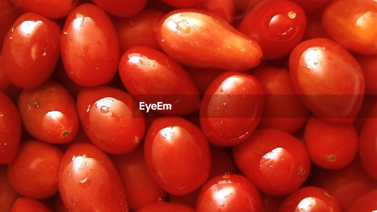 Full frame shot of wet tomatoes at market