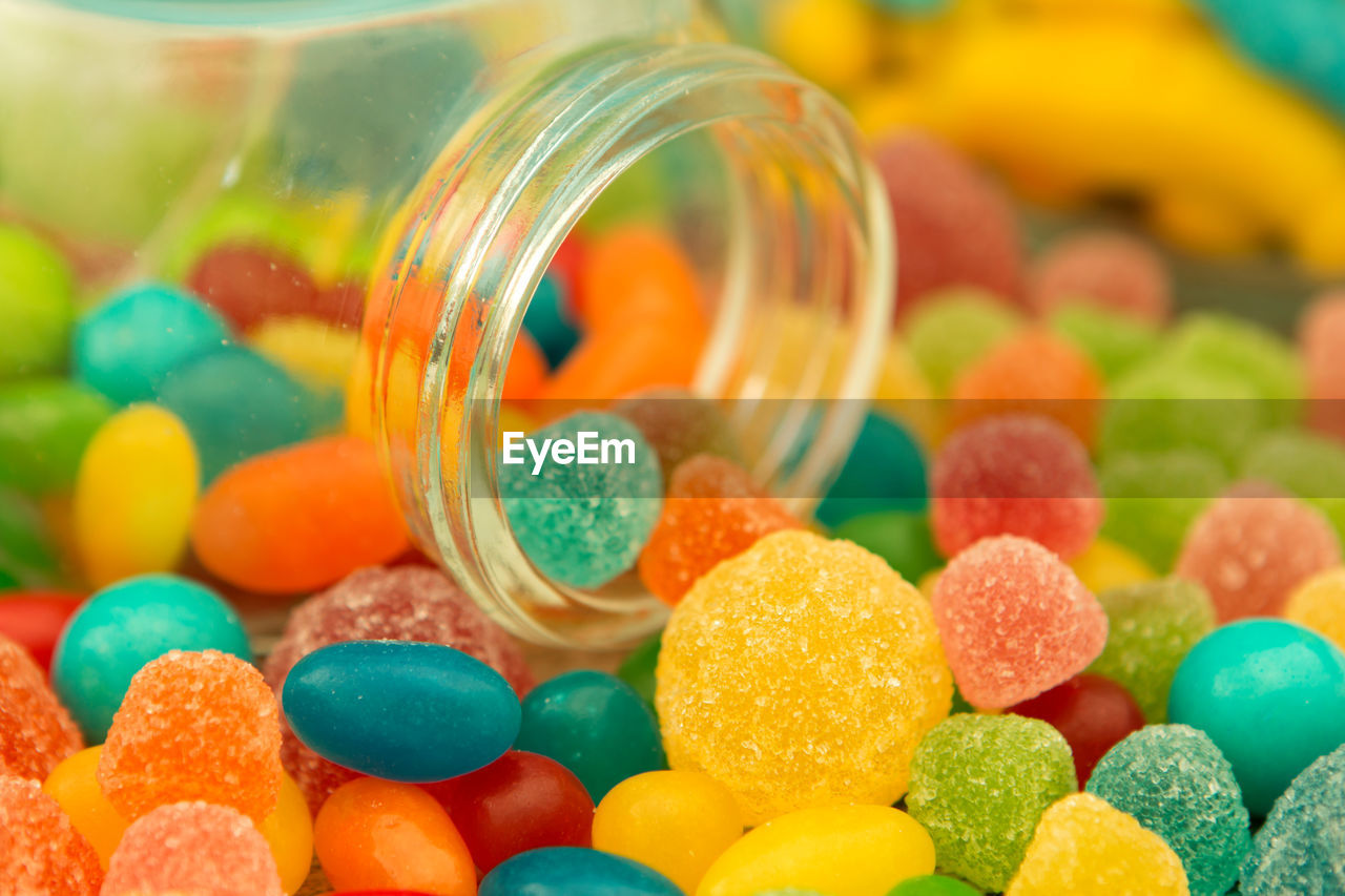 CLOSE-UP OF MULTI COLORED CANDIES IN GLASS CONTAINER