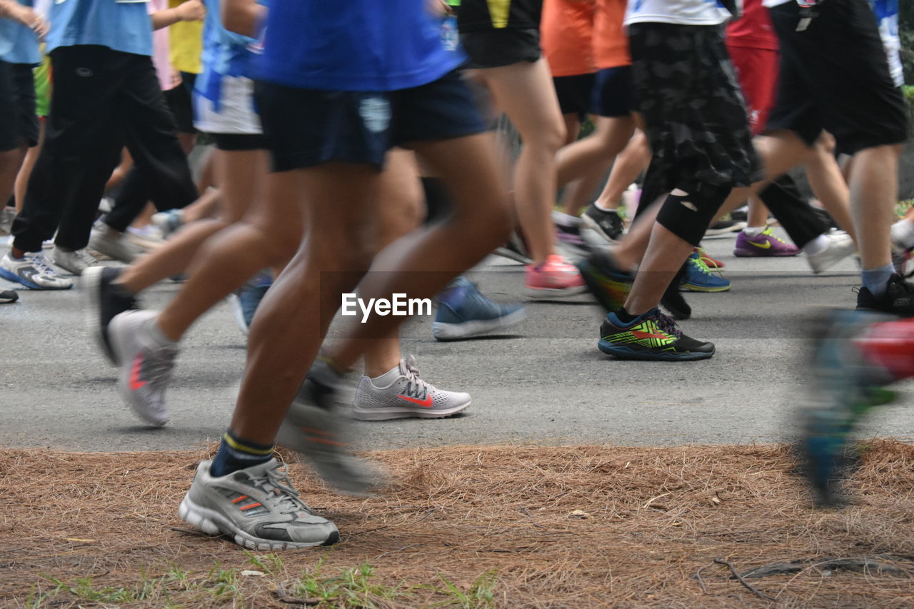 LOW SECTION OF PEOPLE RUNNING