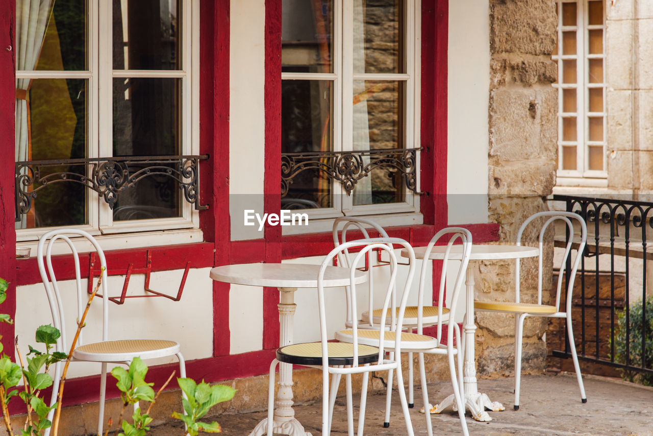 A romantic table and chairs in front of a half-timbered house