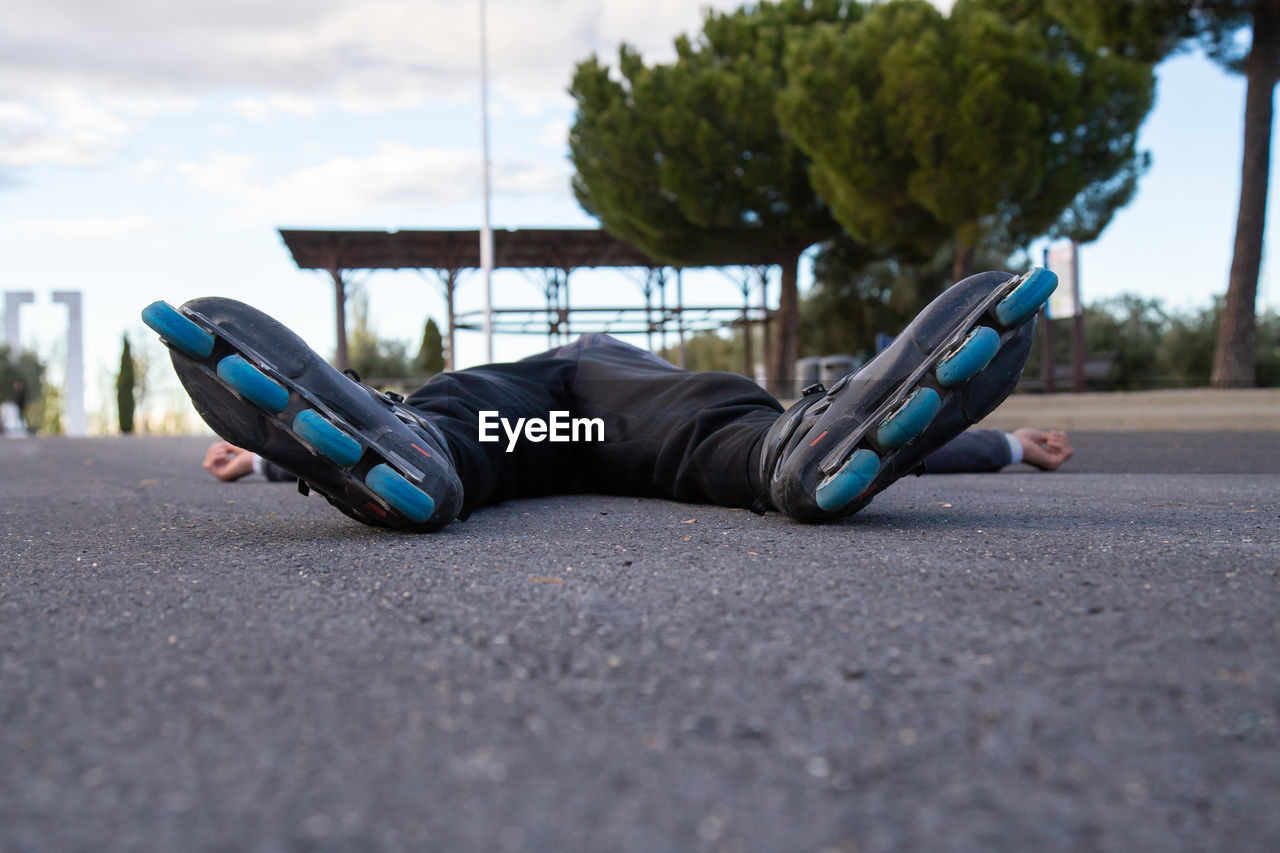 SURFACE LEVEL OF MAN SLEEPING ON ROAD