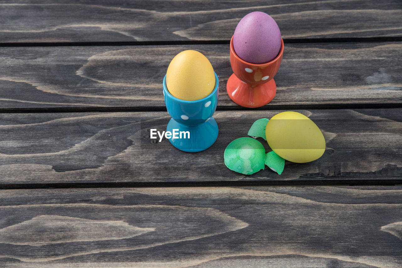 High angle view of easter eggs with cups on table