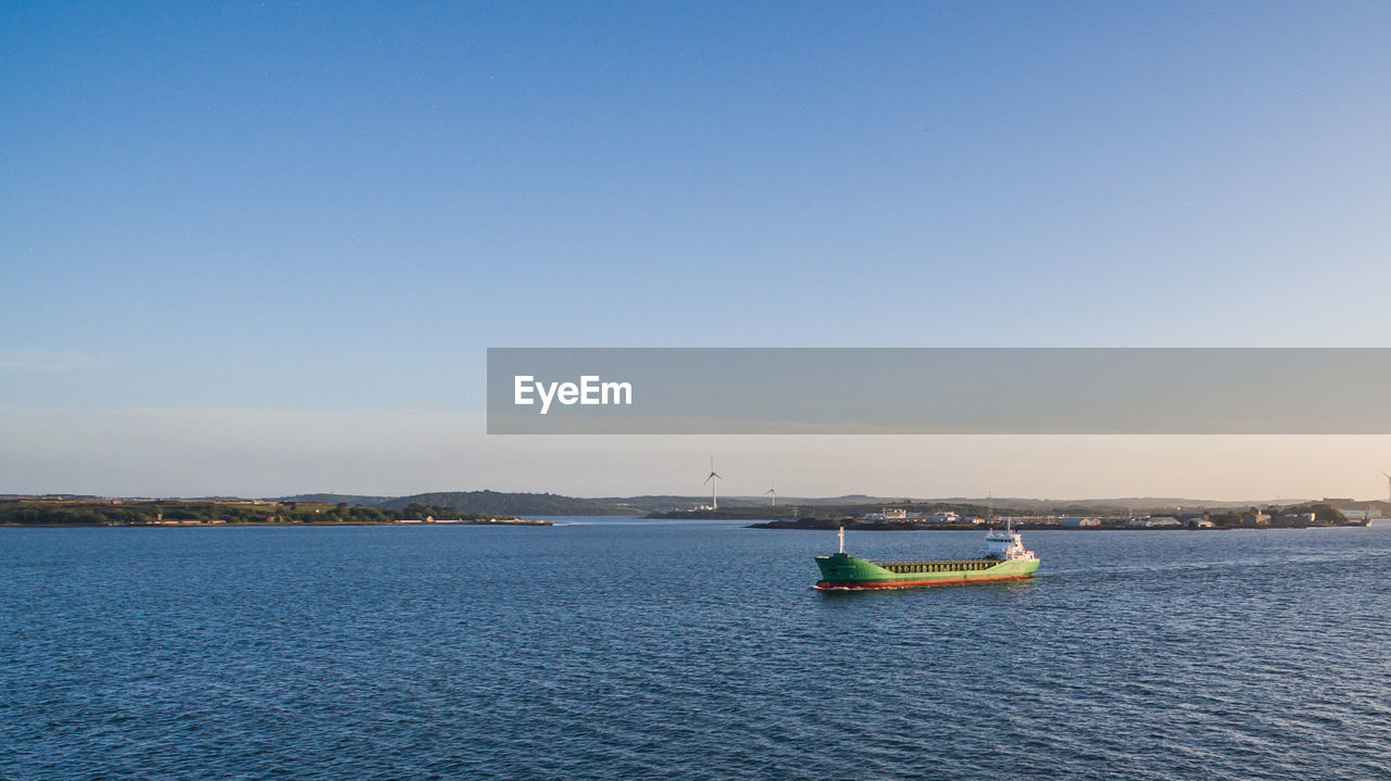 BOAT ON SEA AGAINST CLEAR SKY