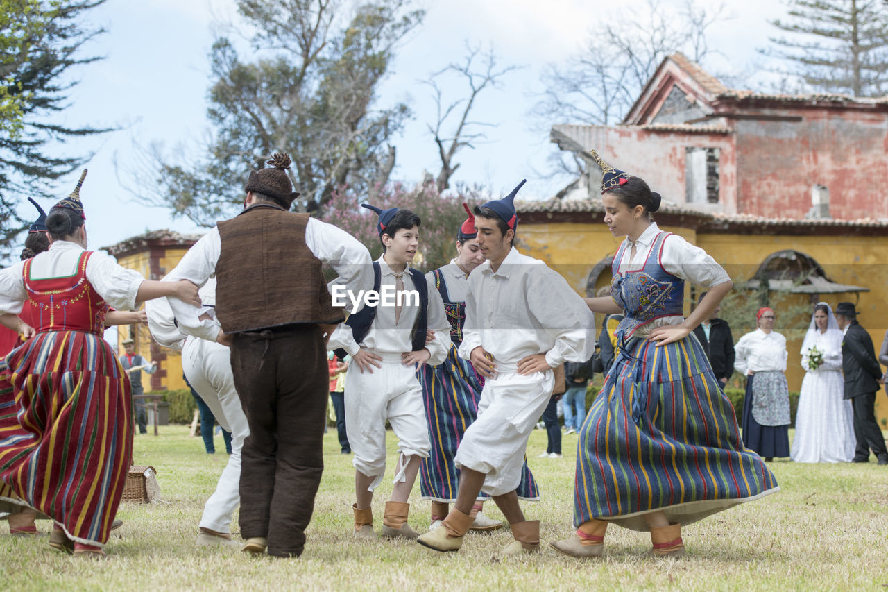 GROUP OF PEOPLE IN TRADITIONAL BUILDING