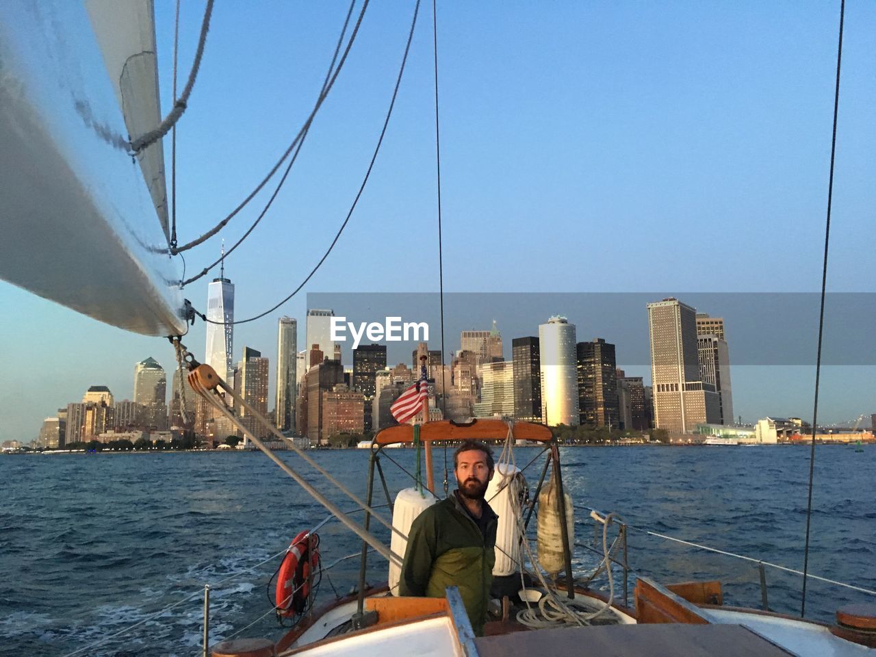 PEOPLE ON BOAT SAILING ON RIVER