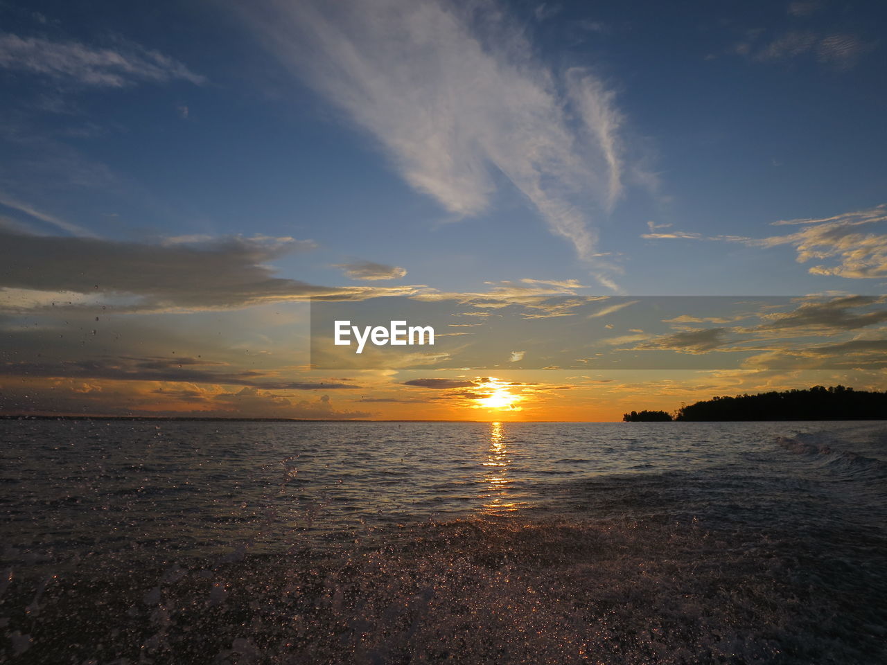 SCENIC VIEW OF SUNSET OVER SEA