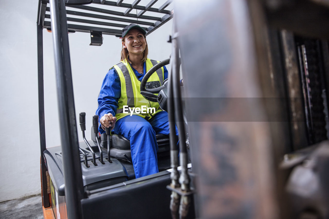 Smiling woman on forklift