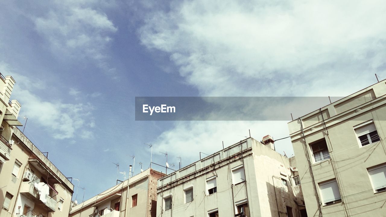 Low angle view of building against cloudy sky