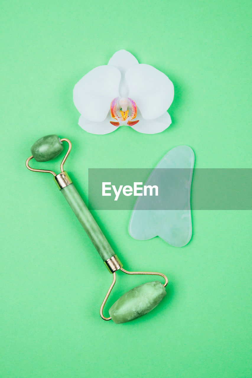 Green face roller and gua sha massager made from natural jade nephritis stone 