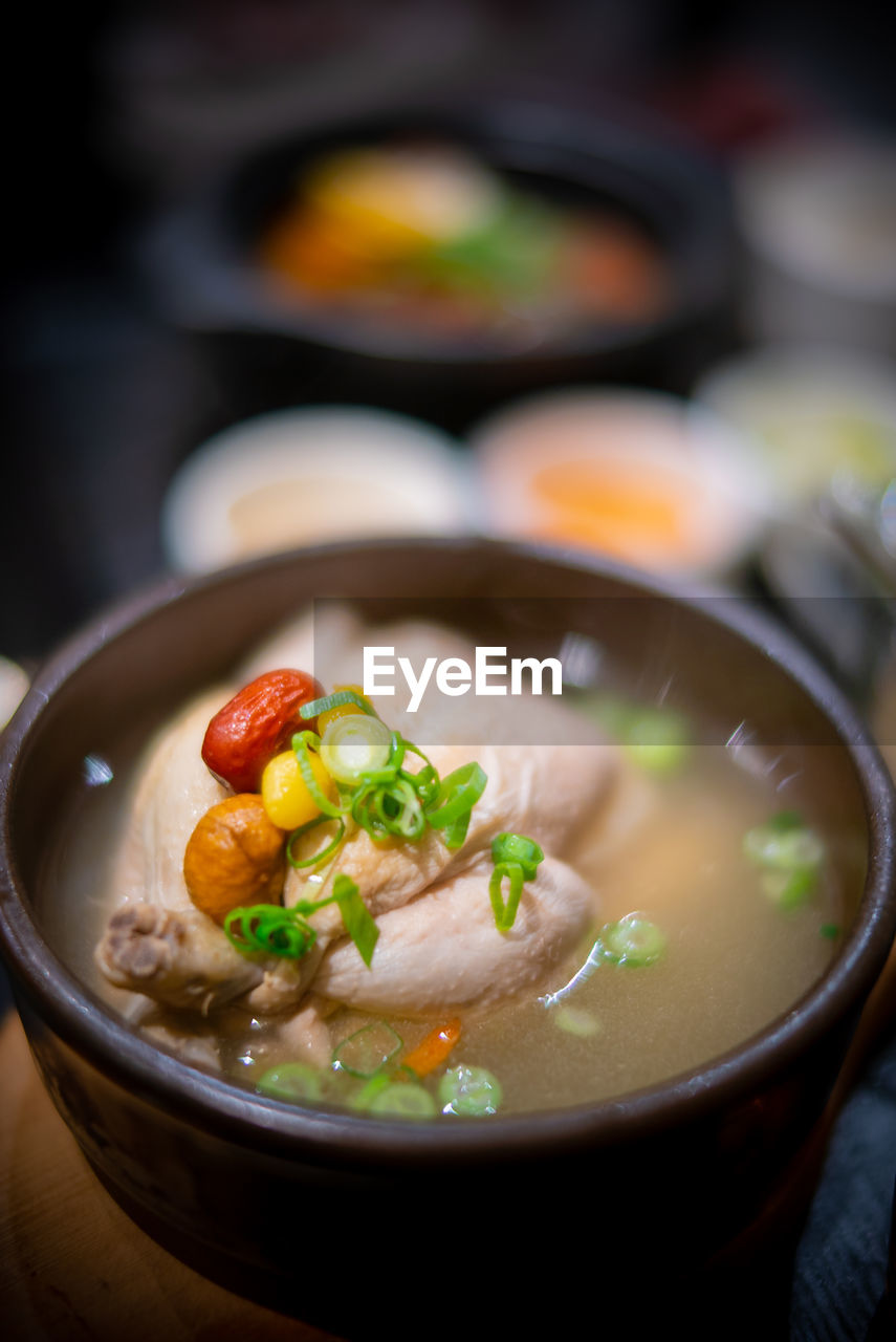 food and drink, food, healthy eating, wellbeing, vegetable, bowl, soup, dish, asian food, freshness, meat, meal, no people, stew, indoors, cuisine, kitchen utensil, close-up, focus on foreground, crockery, seafood, table, selective focus, onion, chinese food
