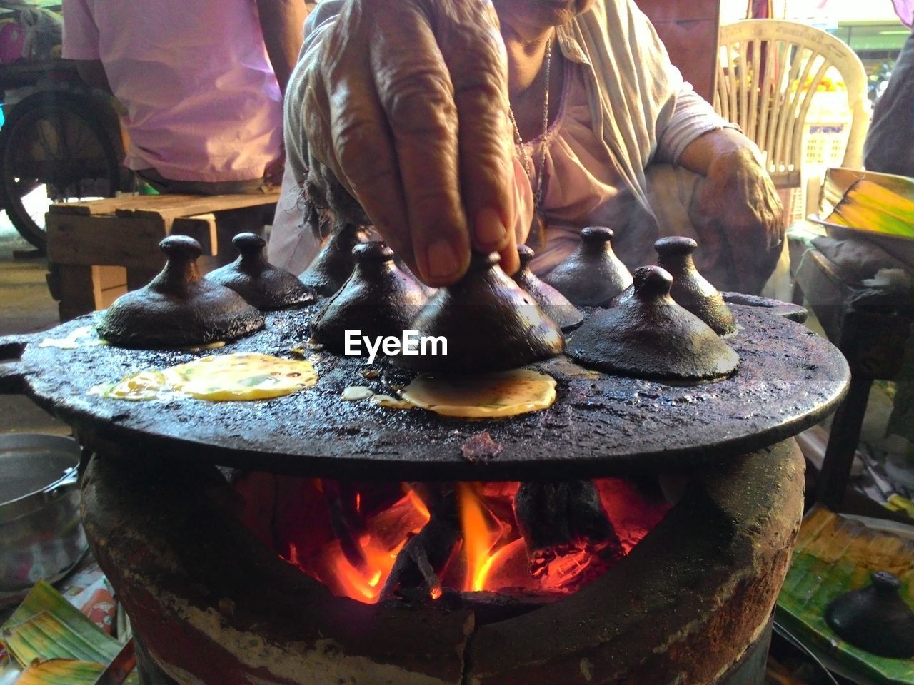 CLOSE-UP OF PREPARING FOOD ON GRILL