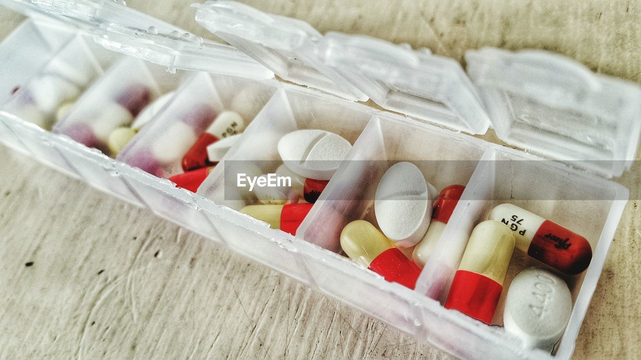 High angle view of medicine pills in container on table
