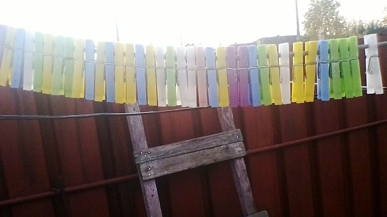 CLOSE-UP OF MULTI COLORED UMBRELLAS HANGING ON CLOTHESLINE