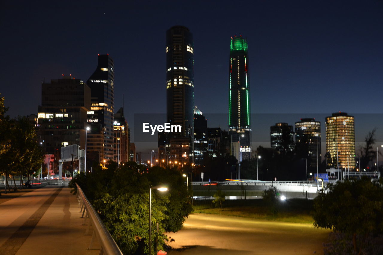 Illuminated city against sky at night