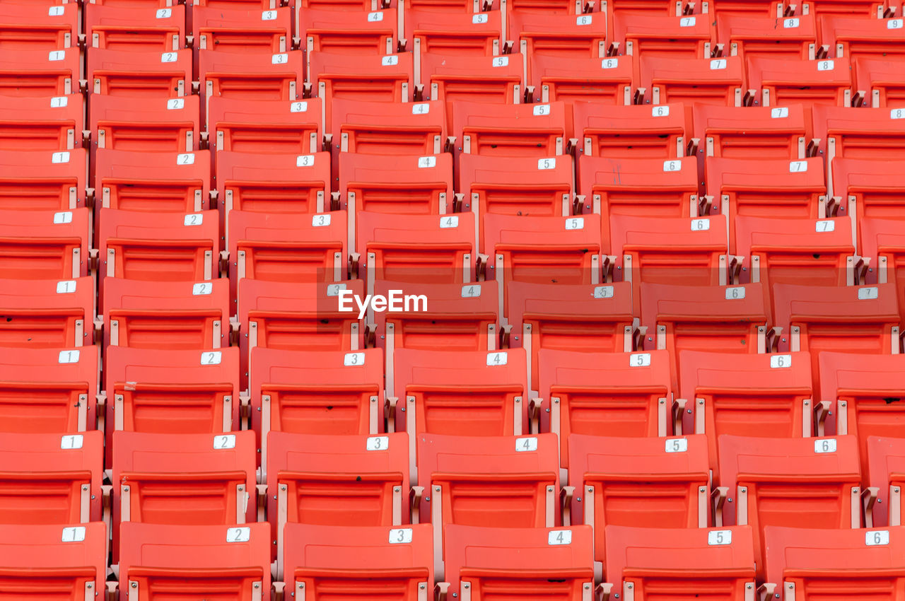 FULL FRAME SHOT OF RED SEATS IN ROW