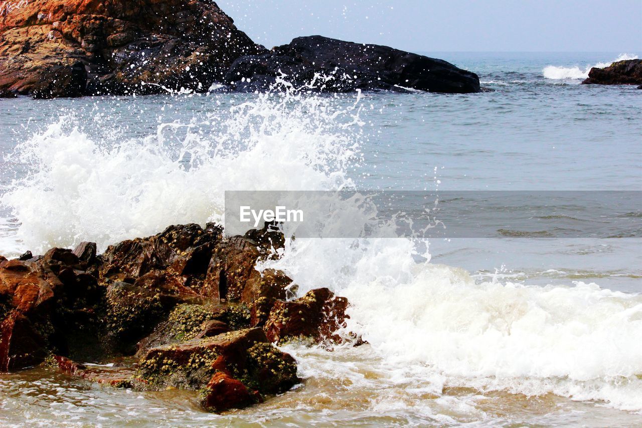 Waves breaking against rocks