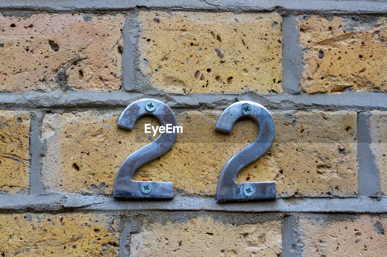 House number 22 on a brick wall in london