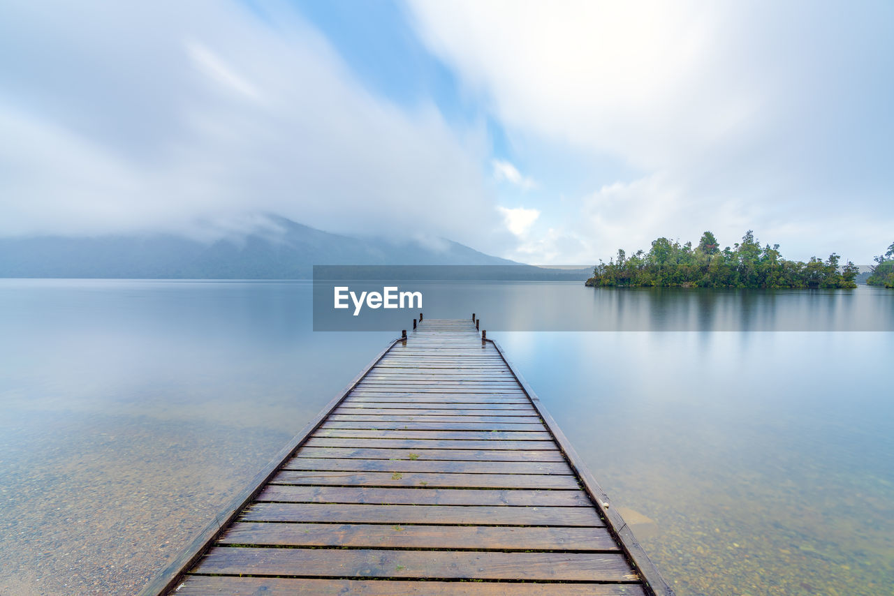 PIER ON LAKE AGAINST SKY