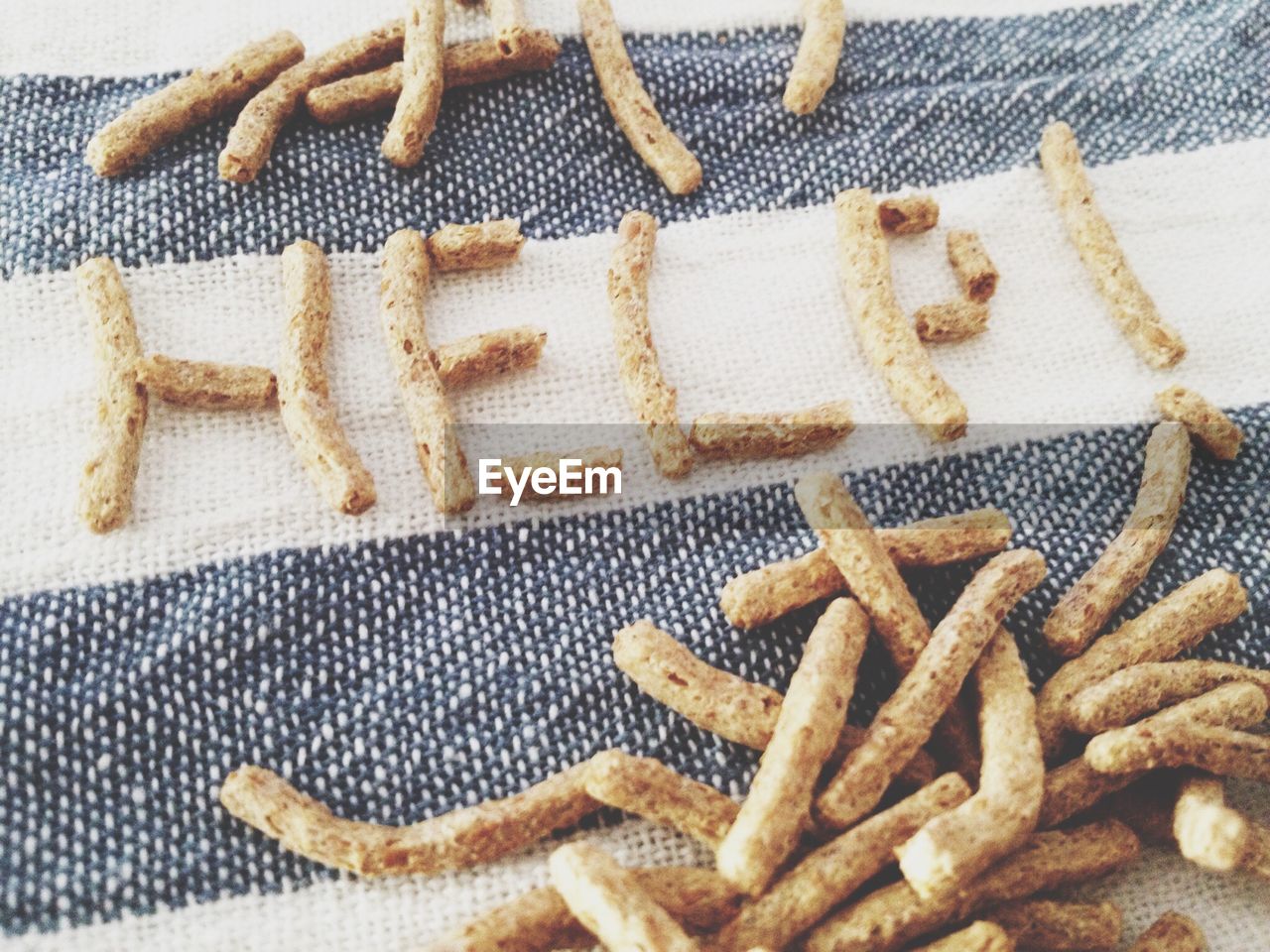 High angle view of help text made from snacks on fabric