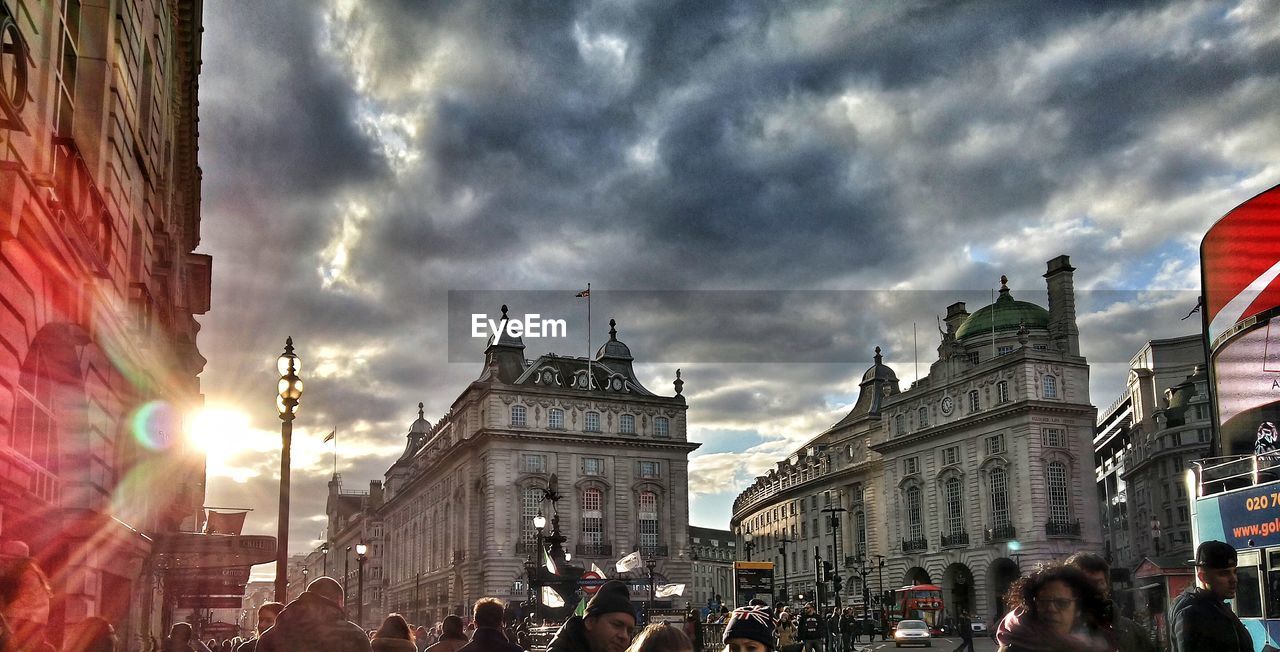 City buildings against cloudy sky