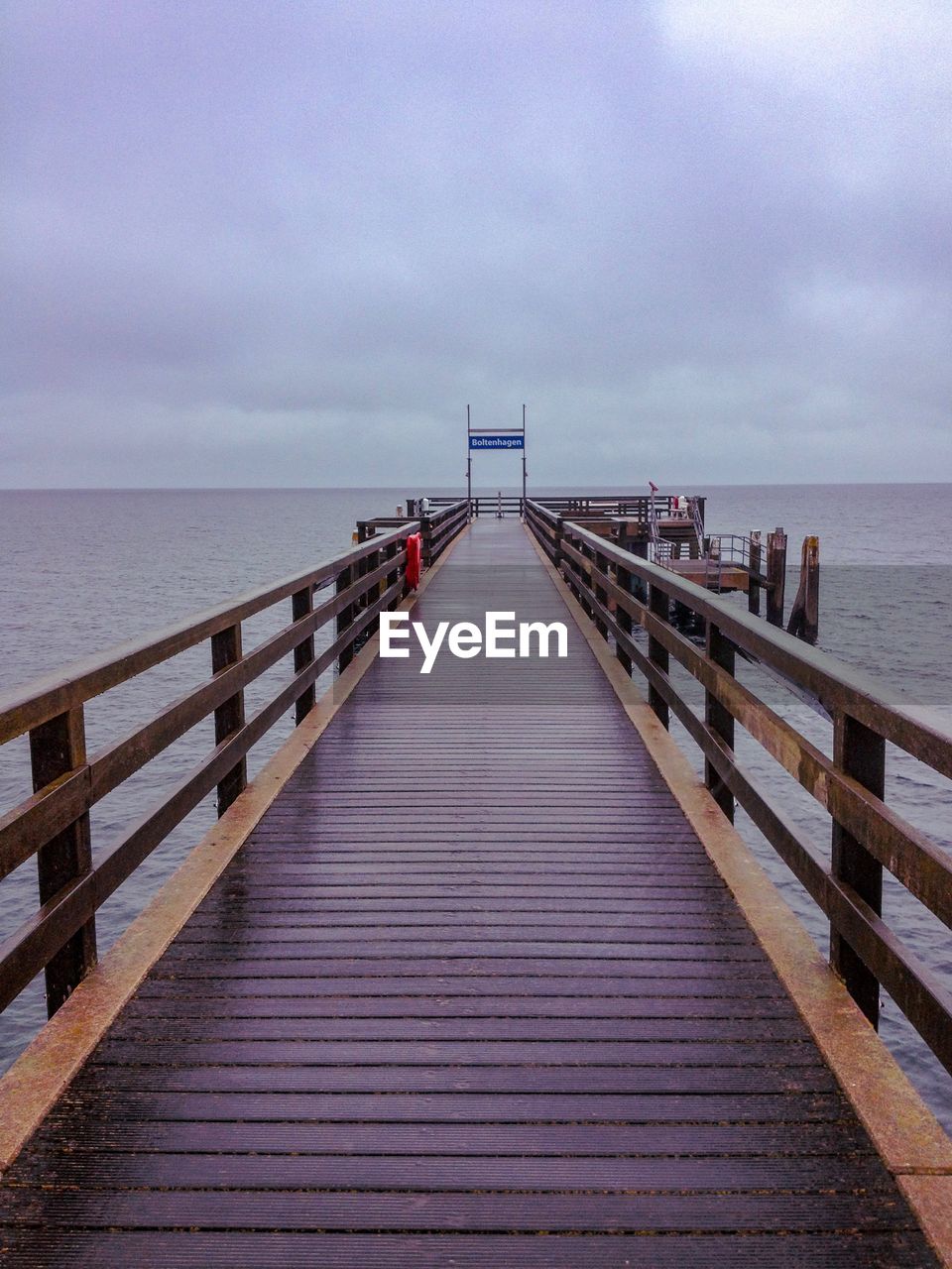 Pier over sea against sky