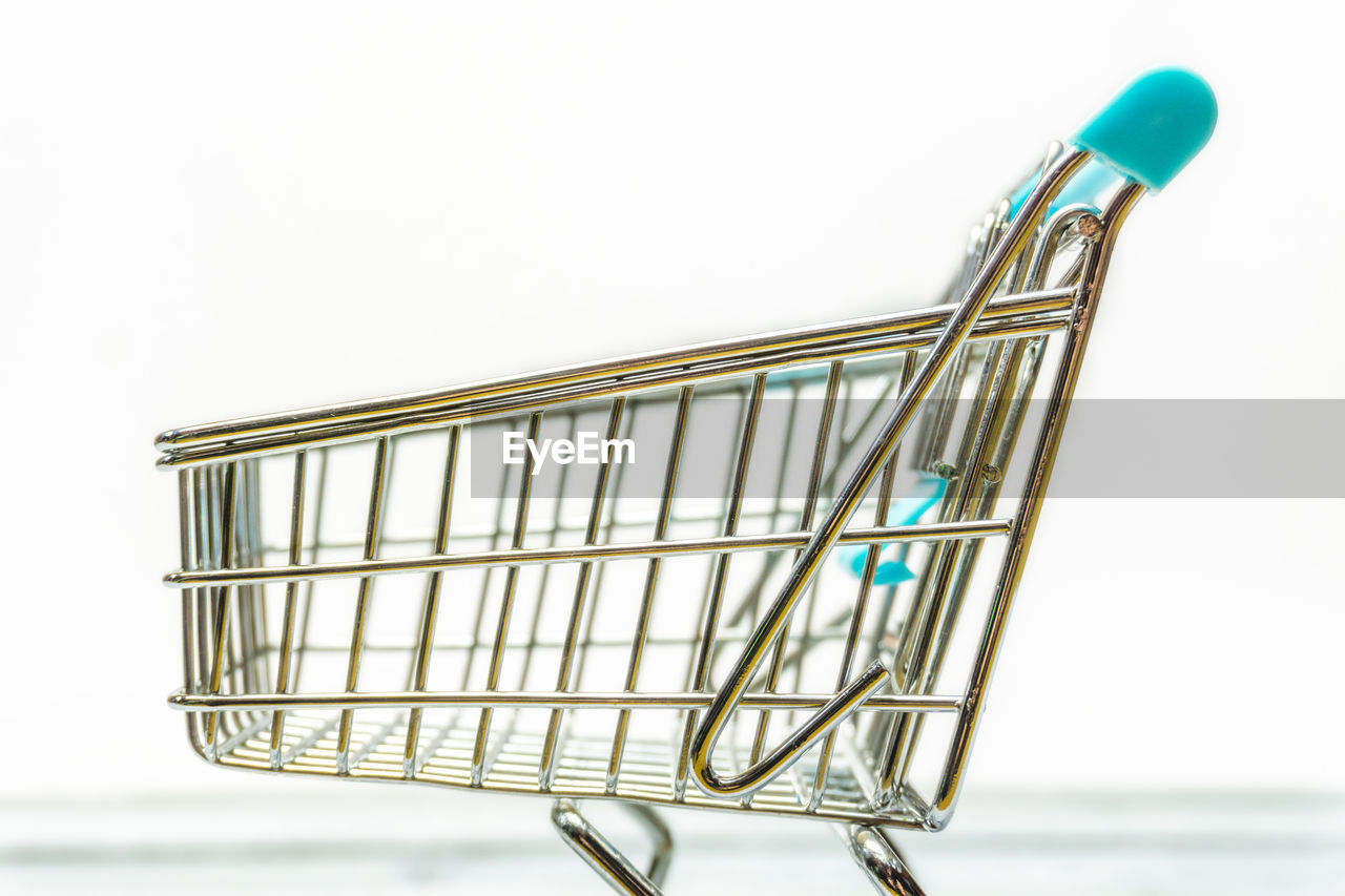 Figurine shopping cart against white background