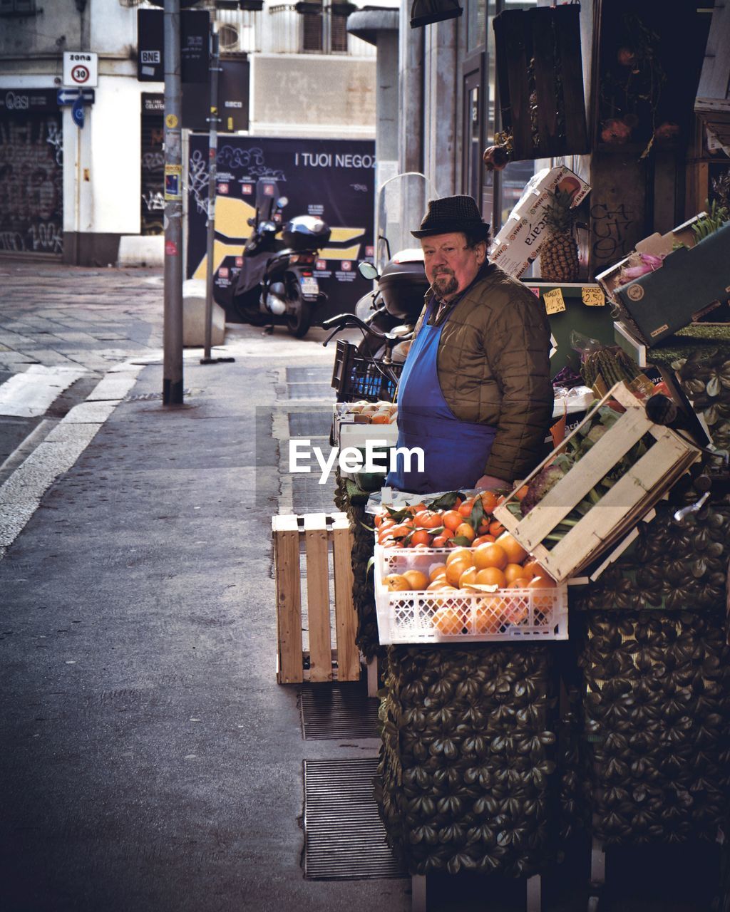 MAN STANDING AT MARKET
