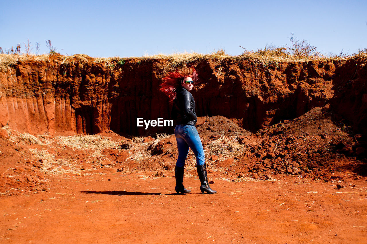 FULL LENGTH OF MAN STANDING ON ROCK