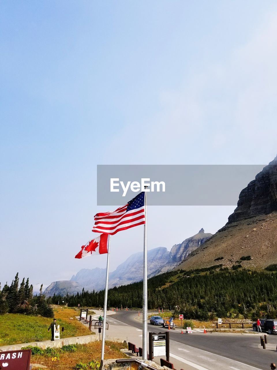 FLAG ON LANDSCAPE AGAINST SKY