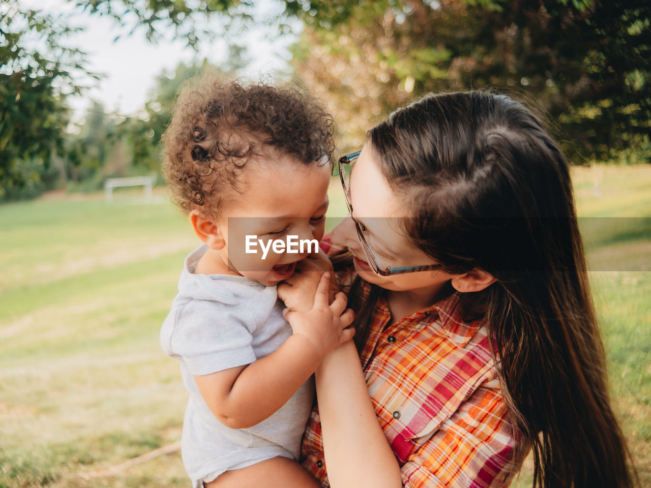 Mother and son embracing in park