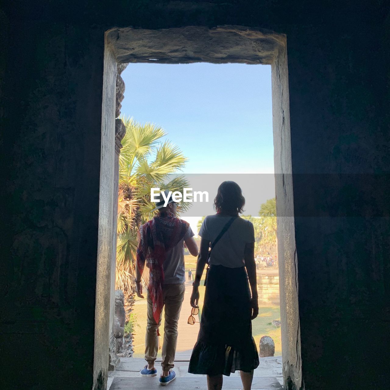 Rear view of couple at entrance of historic building