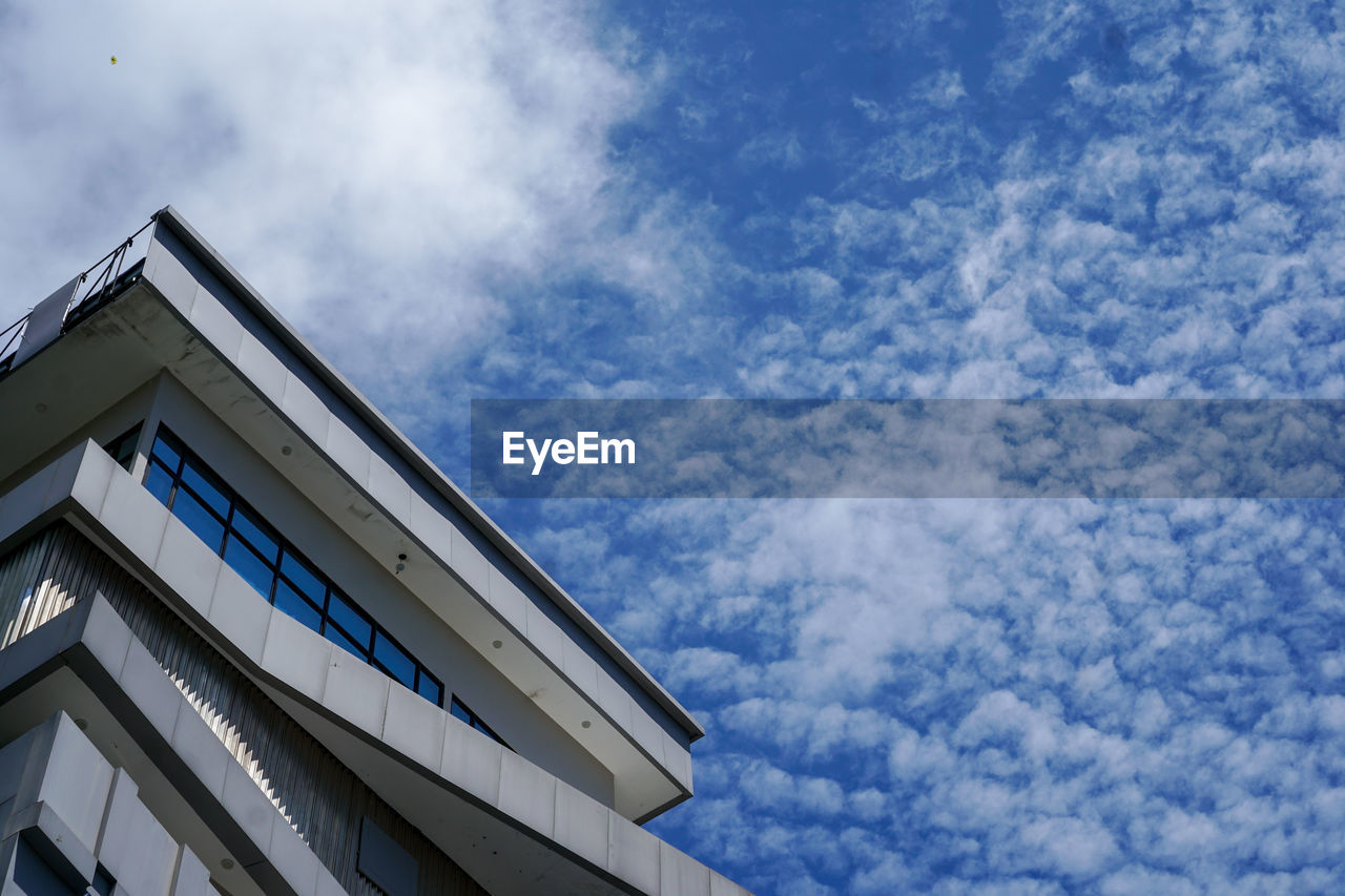 LOW ANGLE VIEW OF BUILDINGS AGAINST BLUE SKY