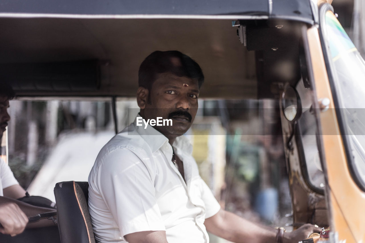 PORTRAIT OF A YOUNG MAN IN BUS