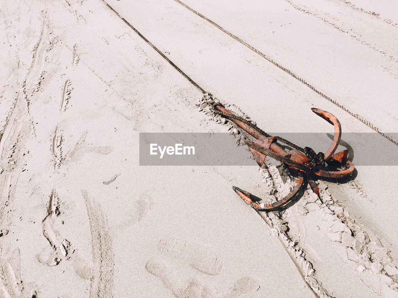 High angle view of anchor on sand