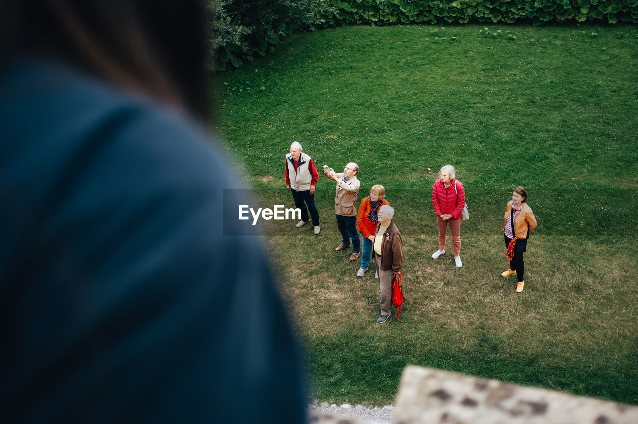 GROUP OF PEOPLE PLAYING ON GRASS