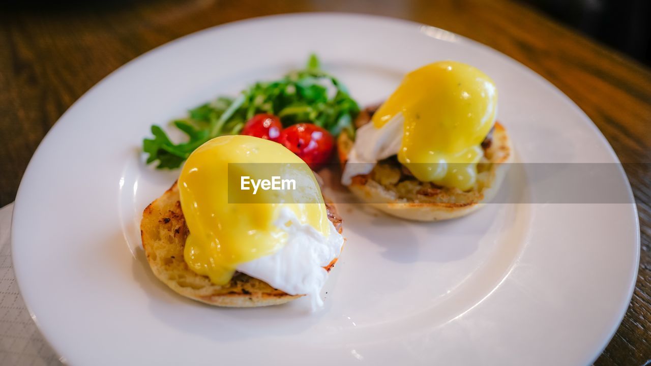 Close-up of eggs benedict in plate on table