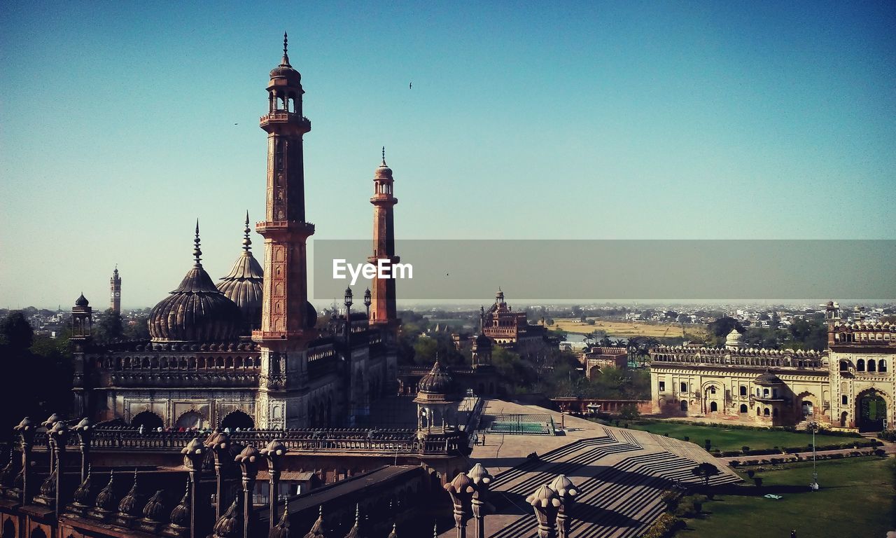 High angle view of mosque against blue sky