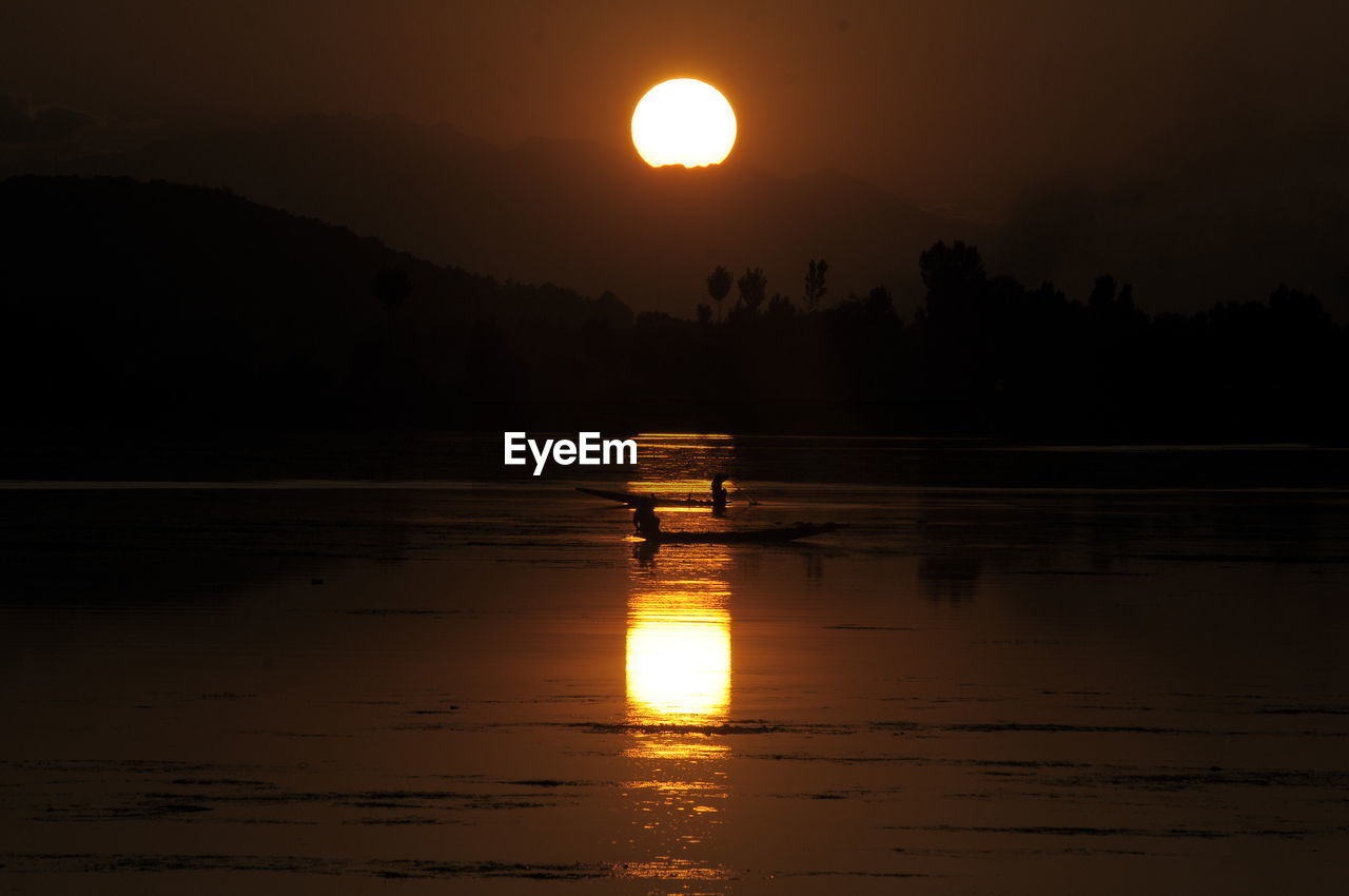 SCENIC VIEW OF LAKE AGAINST ORANGE SKY