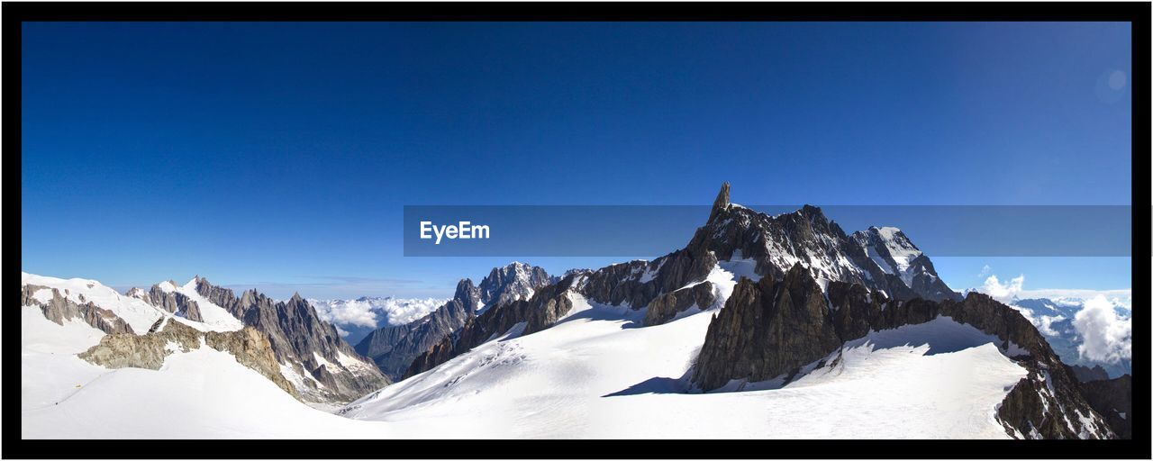 SNOWCAPPED MOUNTAINS AGAINST CLEAR BLUE SKY