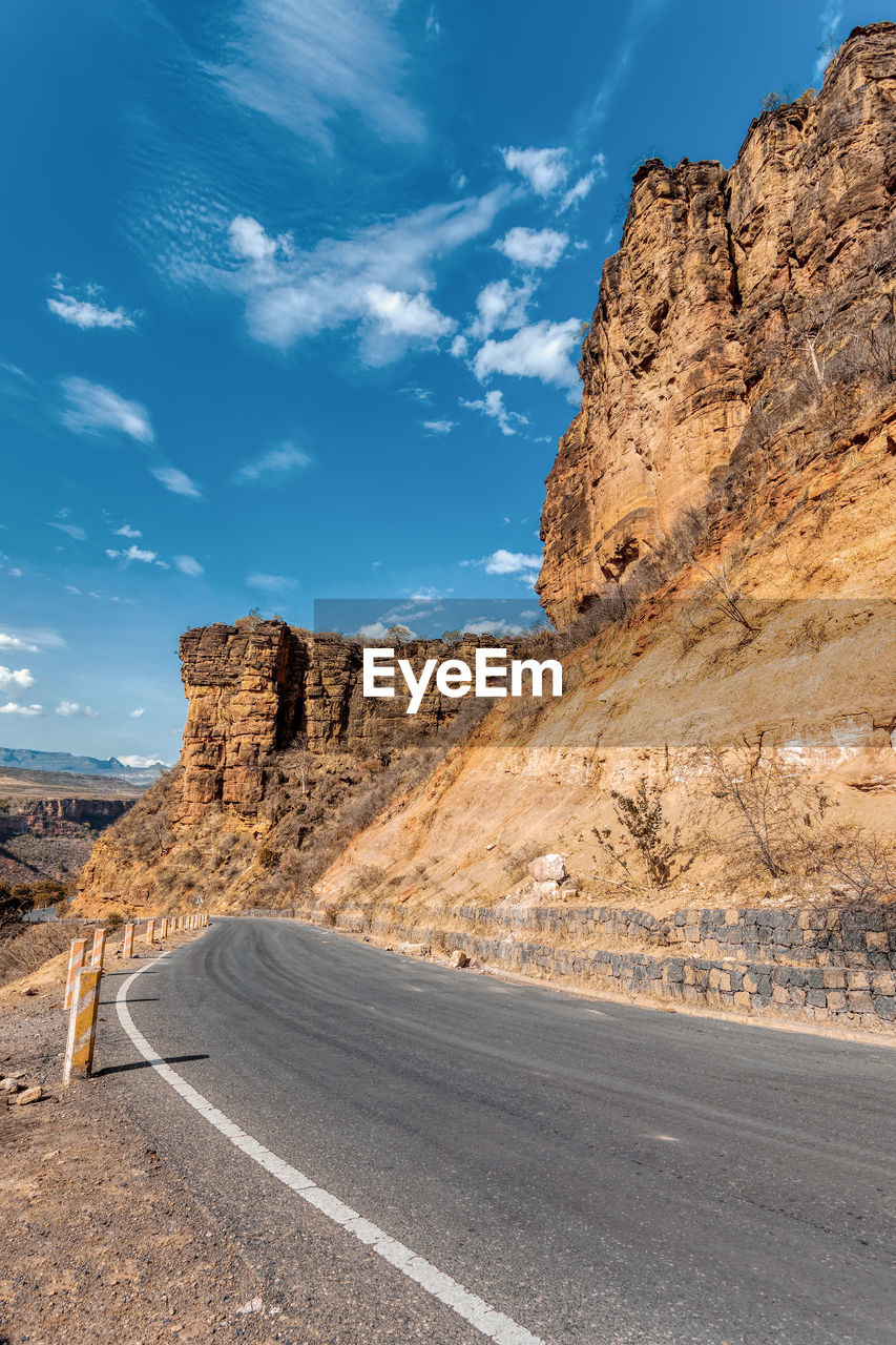 road by mountain against sky