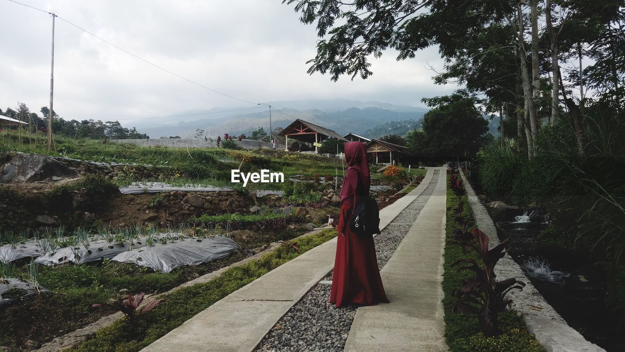 Woman in traditional clothing standing outdoors