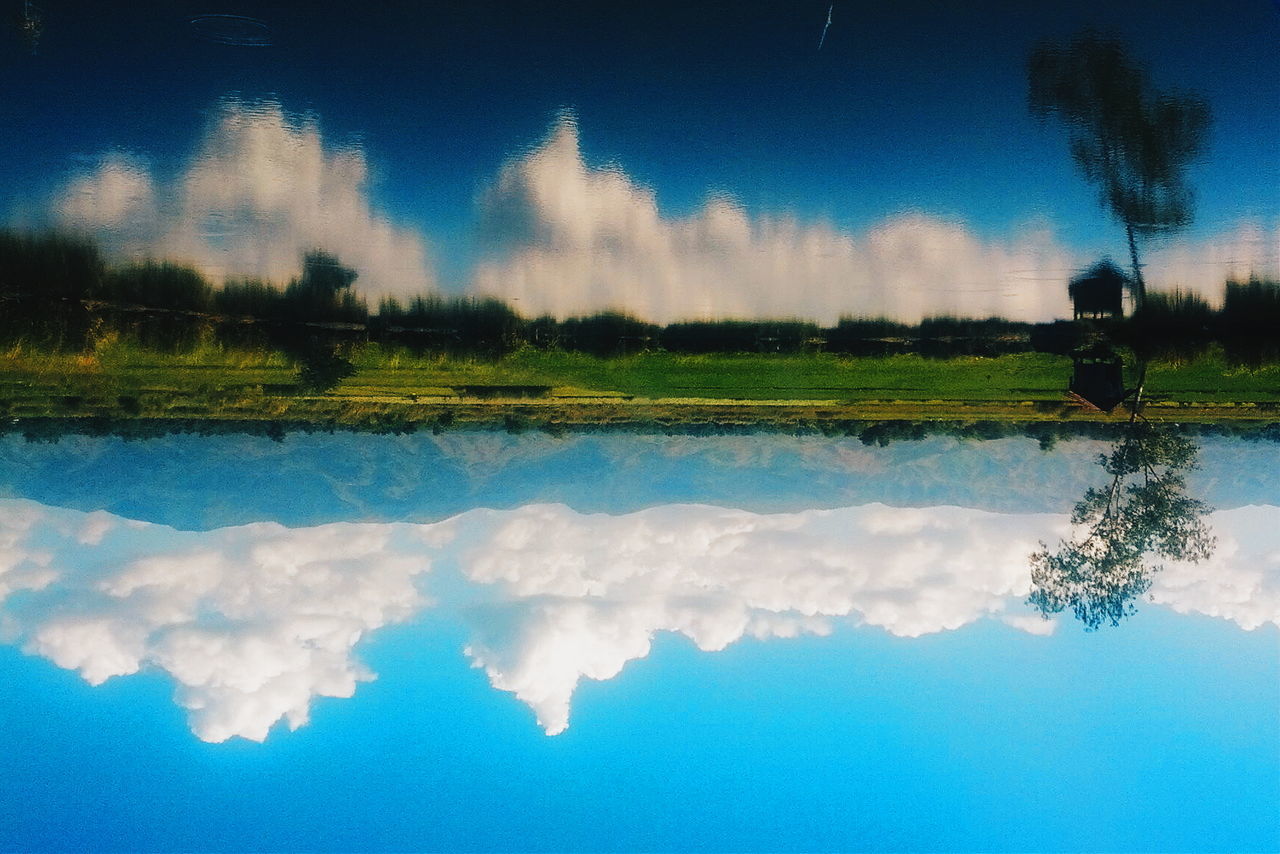 Reflection of clouds in calm lake