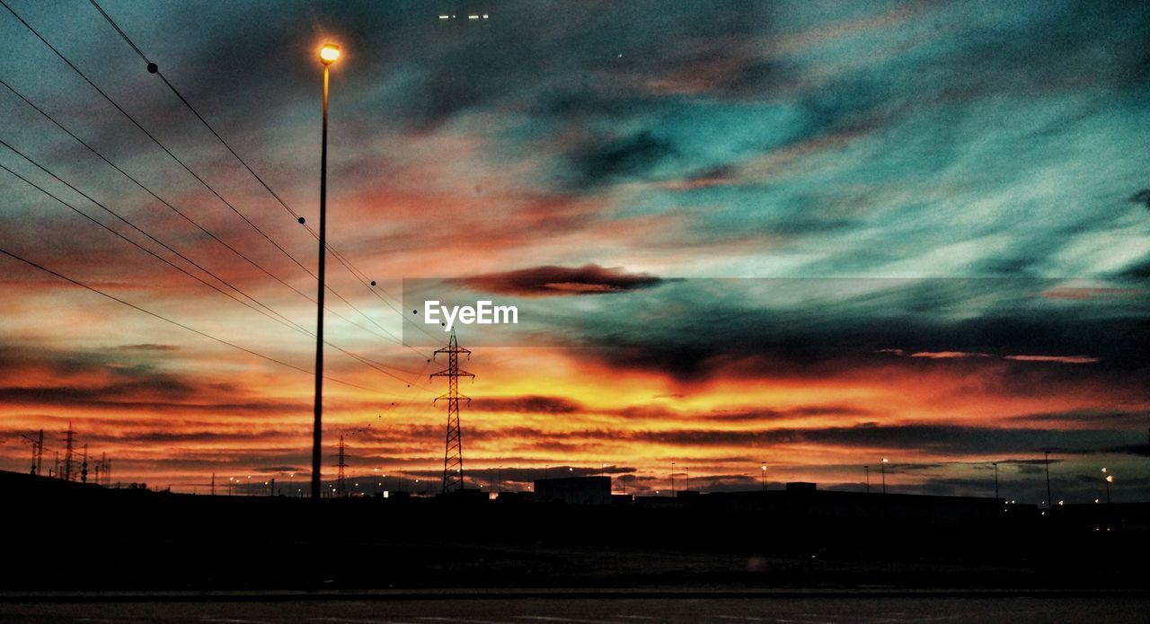 SILHOUETTE CITYSCAPE AGAINST DRAMATIC SKY