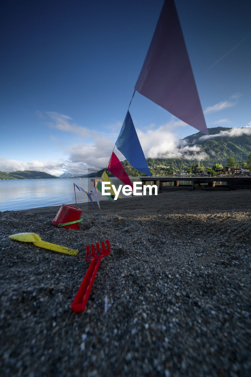 Scenic view over millstätter lake from a beach with jetty to mountains